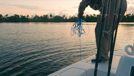 handheld shot of nest fishing fisherman catching fishes on boat, sunset