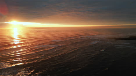 Establishing-Aerial-Drone-Shot-Over-Sea-at-Stunning-Sunrise-in-North-Yorkshire-at-Cleveland-Way-at-Low-Tide-UK