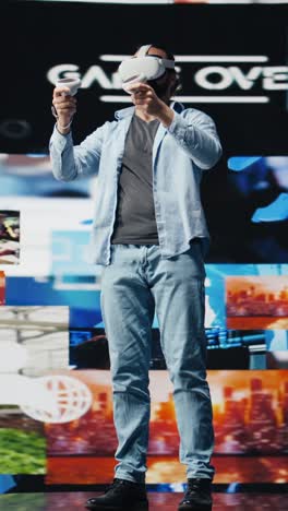 vertical video modern cool man uses virtual reality glasses for a 3d web connection