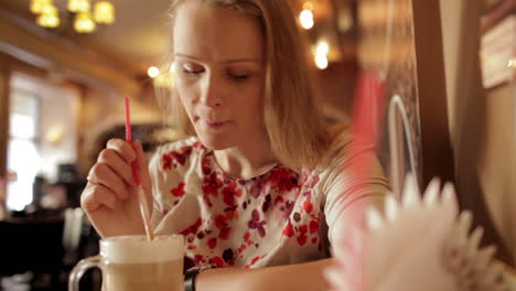 girl is drinking coffee latte in cafe