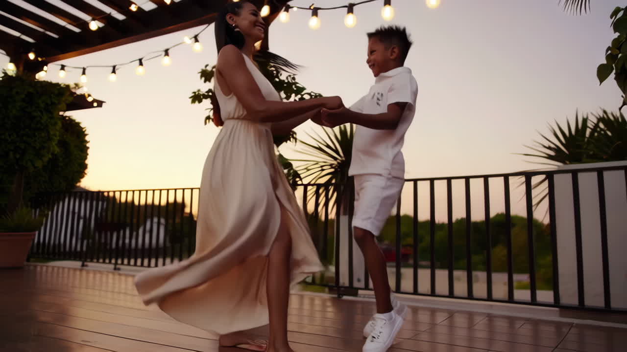 Mother and Son Dancing on a Terrace at Sunset