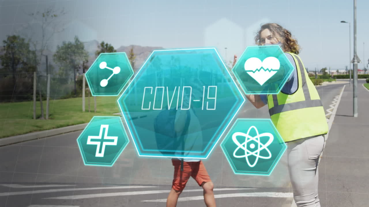 코로나19에 대비해 마스크를 쓴 선생님과 어린이들이 길을 건너고 있는 모습.