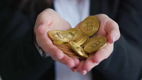 crop businesswoman holding bitcoins