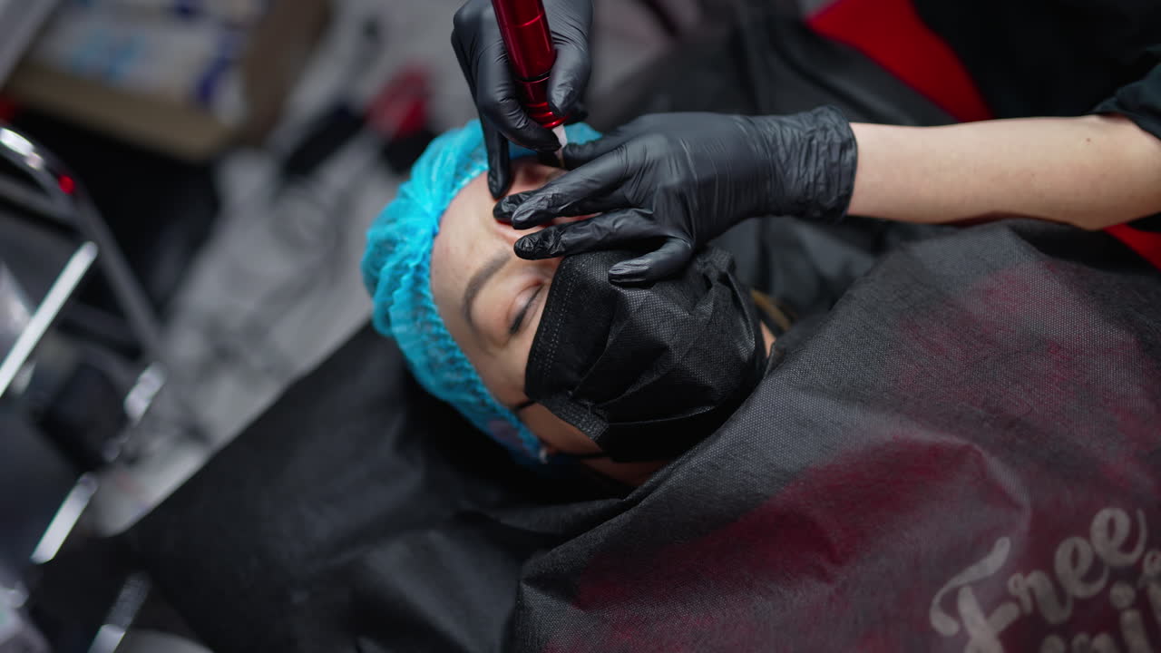 Permanent make up specialist working with skin patient. Permanent eyebrows correction.