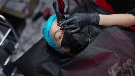 permanent make up specialist working with skin patient. permanent eyebrows correction.