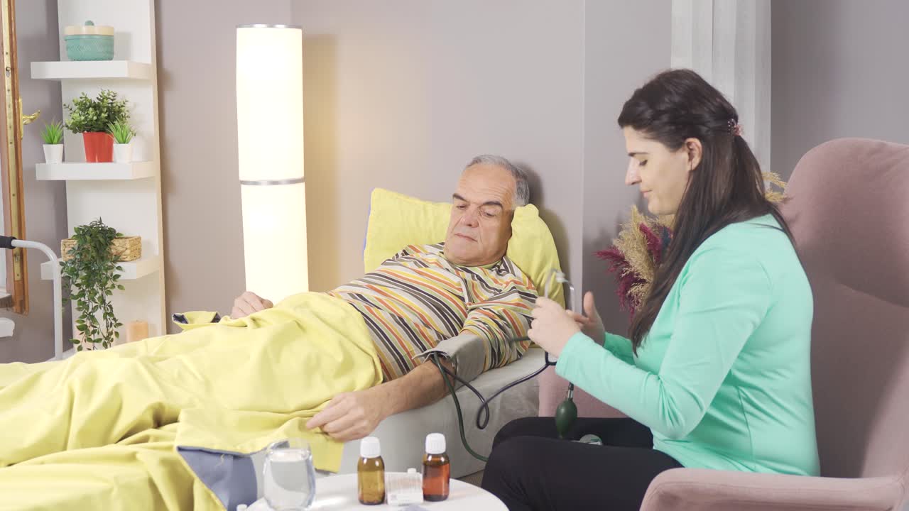 The nurse measures the patient's blood pressure.
