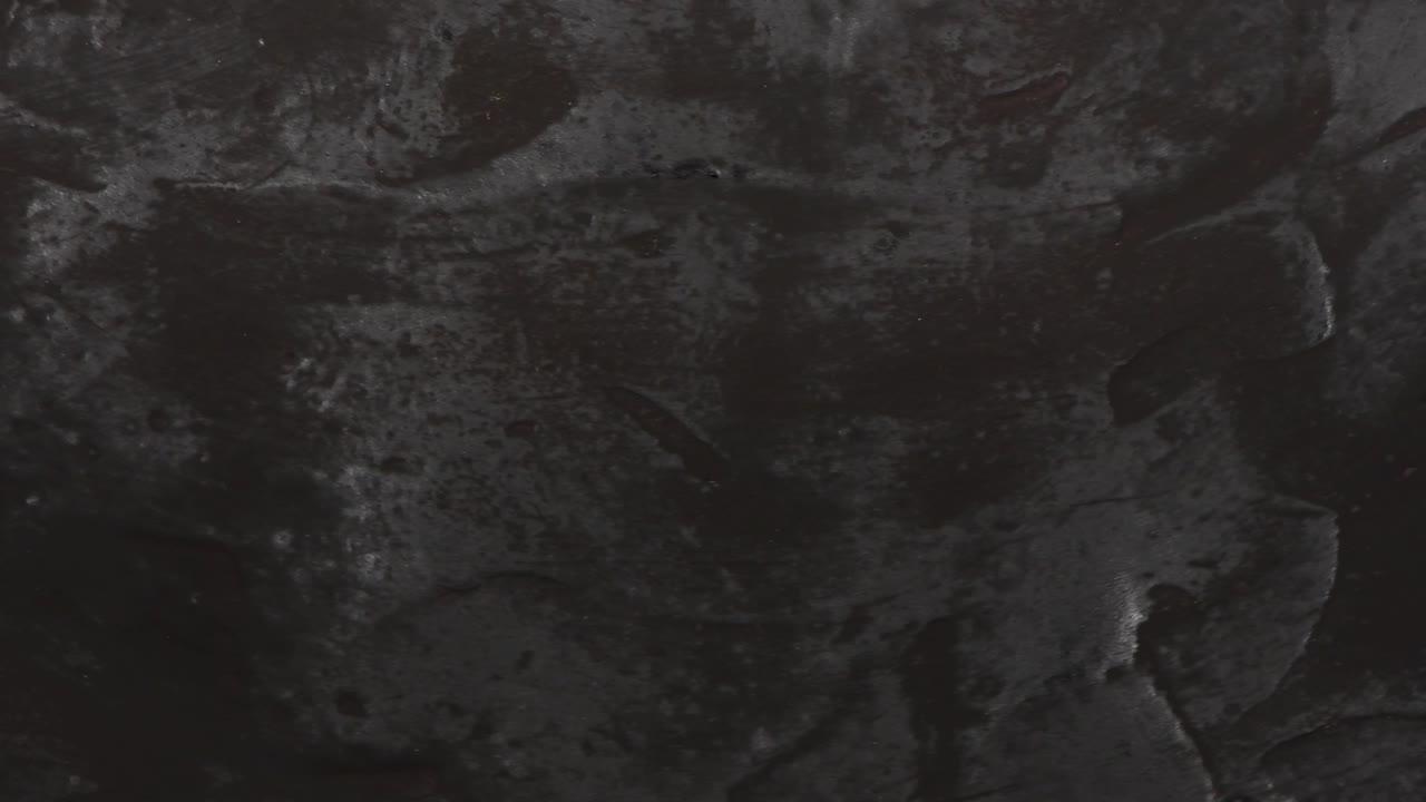 fondo de textura negra. vista superior. movimiento en bucle. rotación 360.