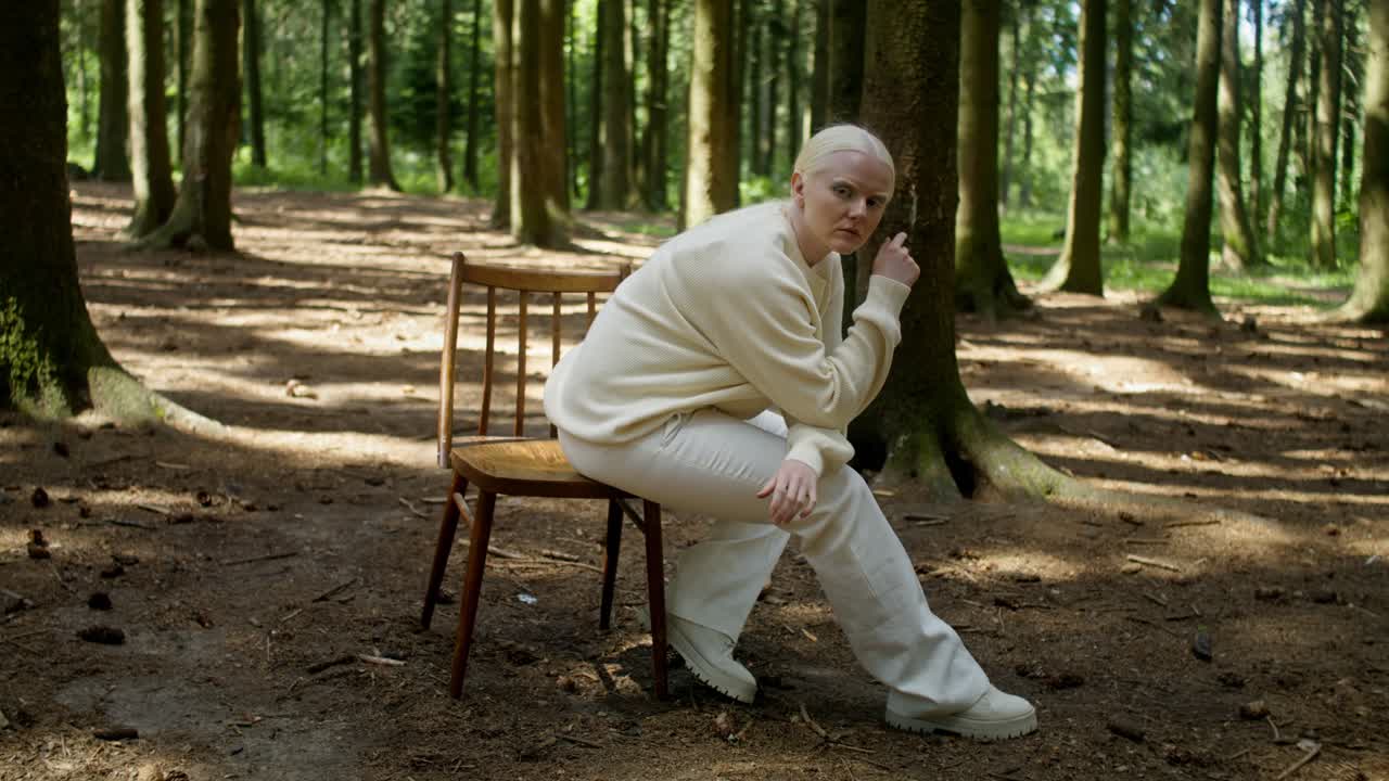 Woman sitting on a chair in a forest