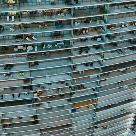 descending along the huge residential block of flats with spacious balconies. drone footage of a house in miami. top view.