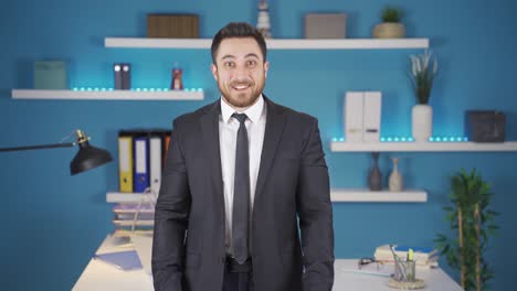 cute businessman looking at camera getting happy.