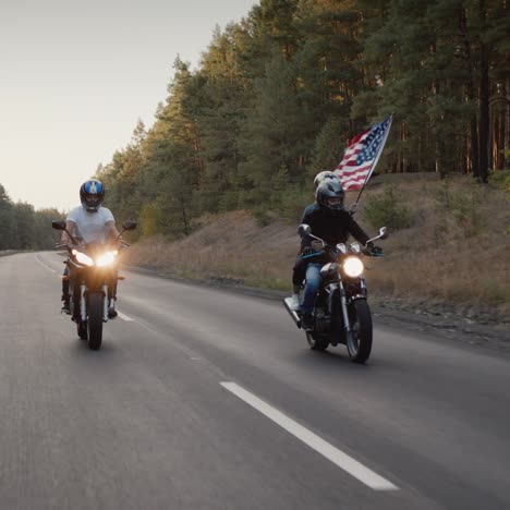young people on high-speed motorcycles ride on the highway 1