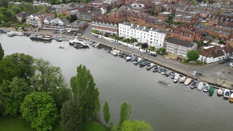 henley on thames waterfront boats moored and rowers moving along rive oxfordshire uk aerial footage