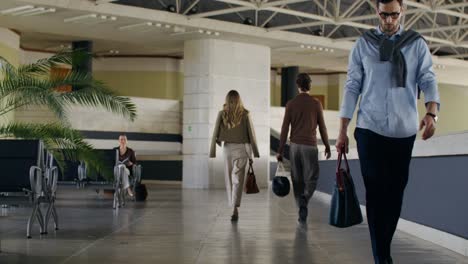 business people walking in an airport lounge