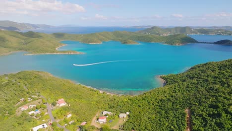 Caribbean-Island-chain-with-boats-crossing-Coral-Bay,-St