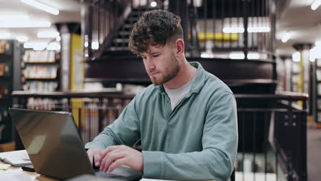 young man studying in a library