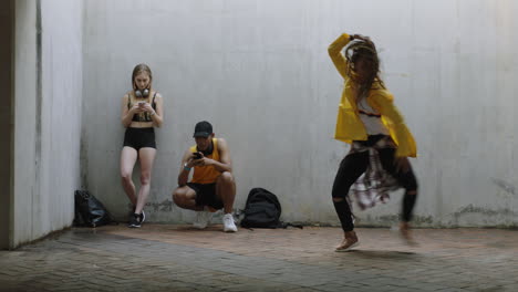 dancing-woman-young-happy-street-dancer-performing-freestyle-moves-friends-watching-enjoying-dance-in-grungy-urban-warehouse