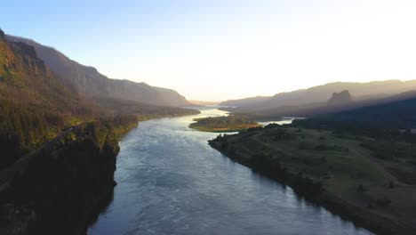 slow flight over the colombia river gorge in oregon at sunset with misty hills