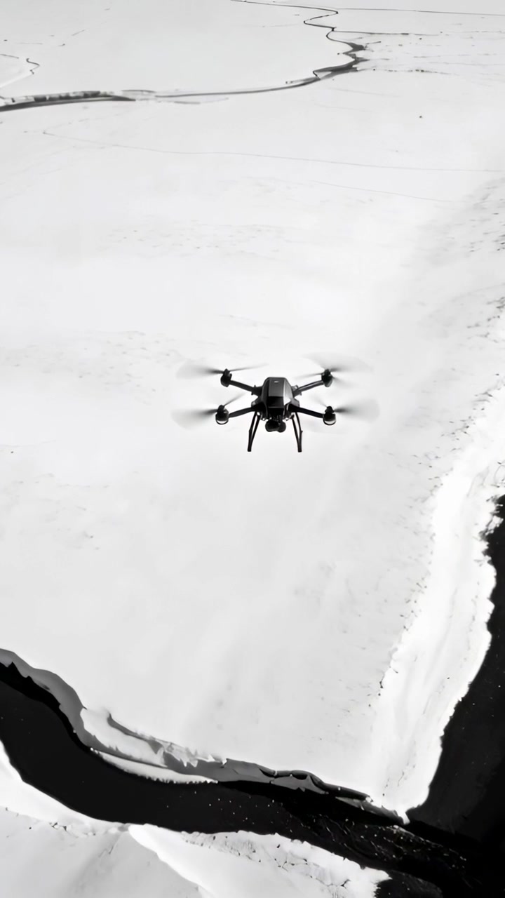 Vertical video: Receiving autopilot signal, hexacopter drone advancing over snow river with gimbal