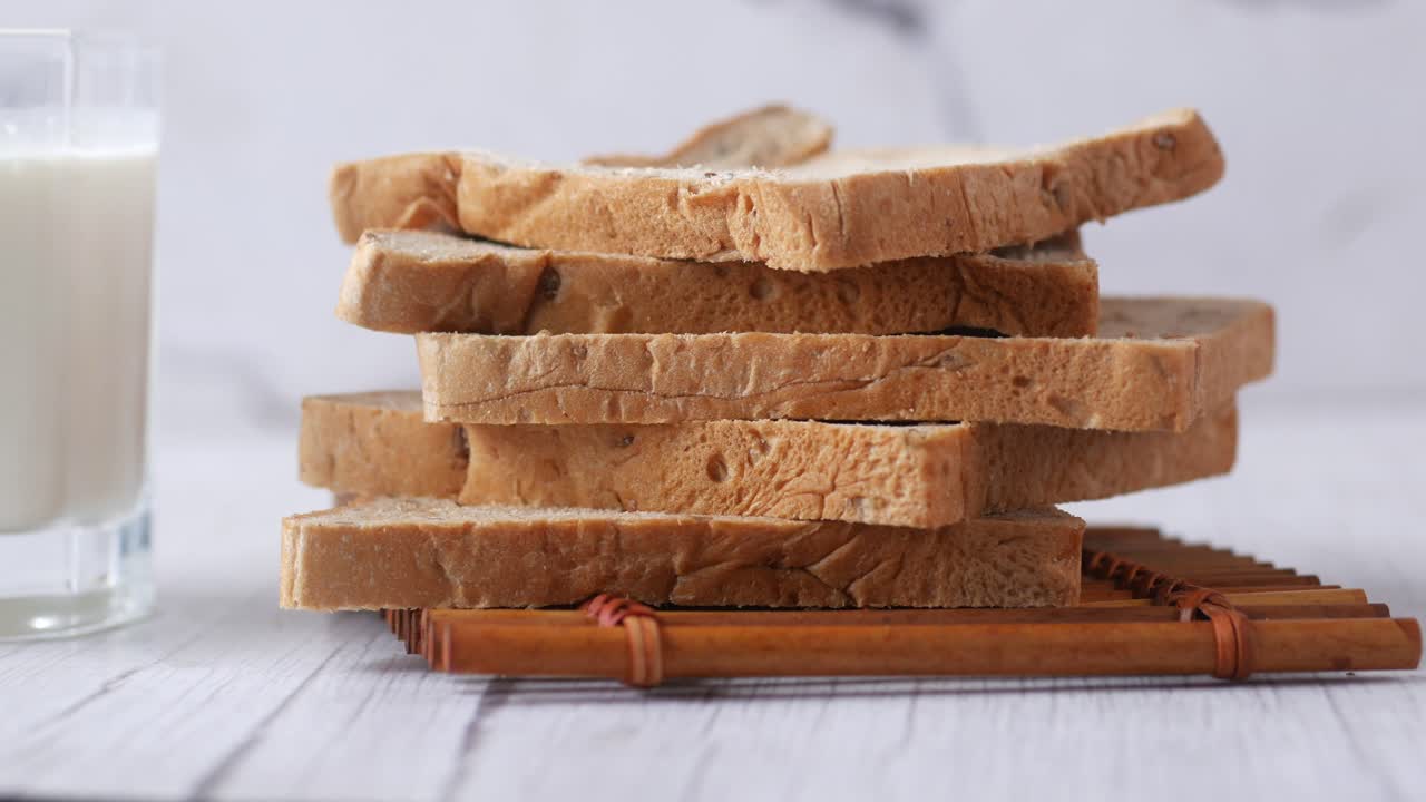 Stack of bread and glass of milk on table ,