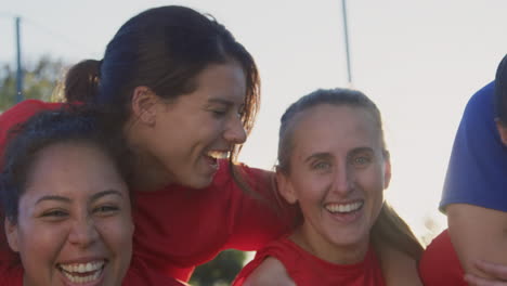 portrait of womens soccer team celebrating after game together