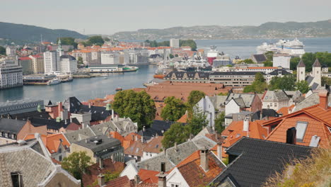 a view from above on the city of bergen below are visible the roofs of old houses and and bay with a