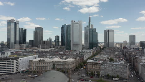 AERIAL:-Forward-Flight-over-Frankfurt-am-Main,-Germany-Central-Train-Station-with-Skyline-View-on-beautiful-Summer-Day-with-little-Traffic-due-to-Coronavirus-Covid-19-Pandemic