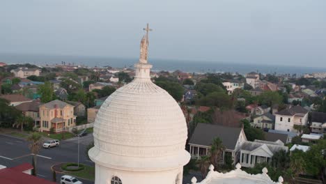 Drone-view-of-Statue-on-top-of-the-Sacred-Heart-Catholic-Church-in-Galveston,-Texas