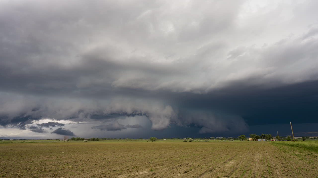 Mesmerizing Storm Clouds Roll Across The Summer Sky Over Farm Land