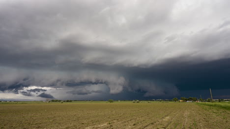 mesmerizing storm clouds roll across the summer sky over farm land