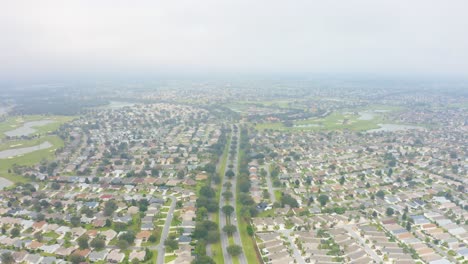 aerial drone shot rising about the streets and myriad houses of the villages, florida on a foggy day