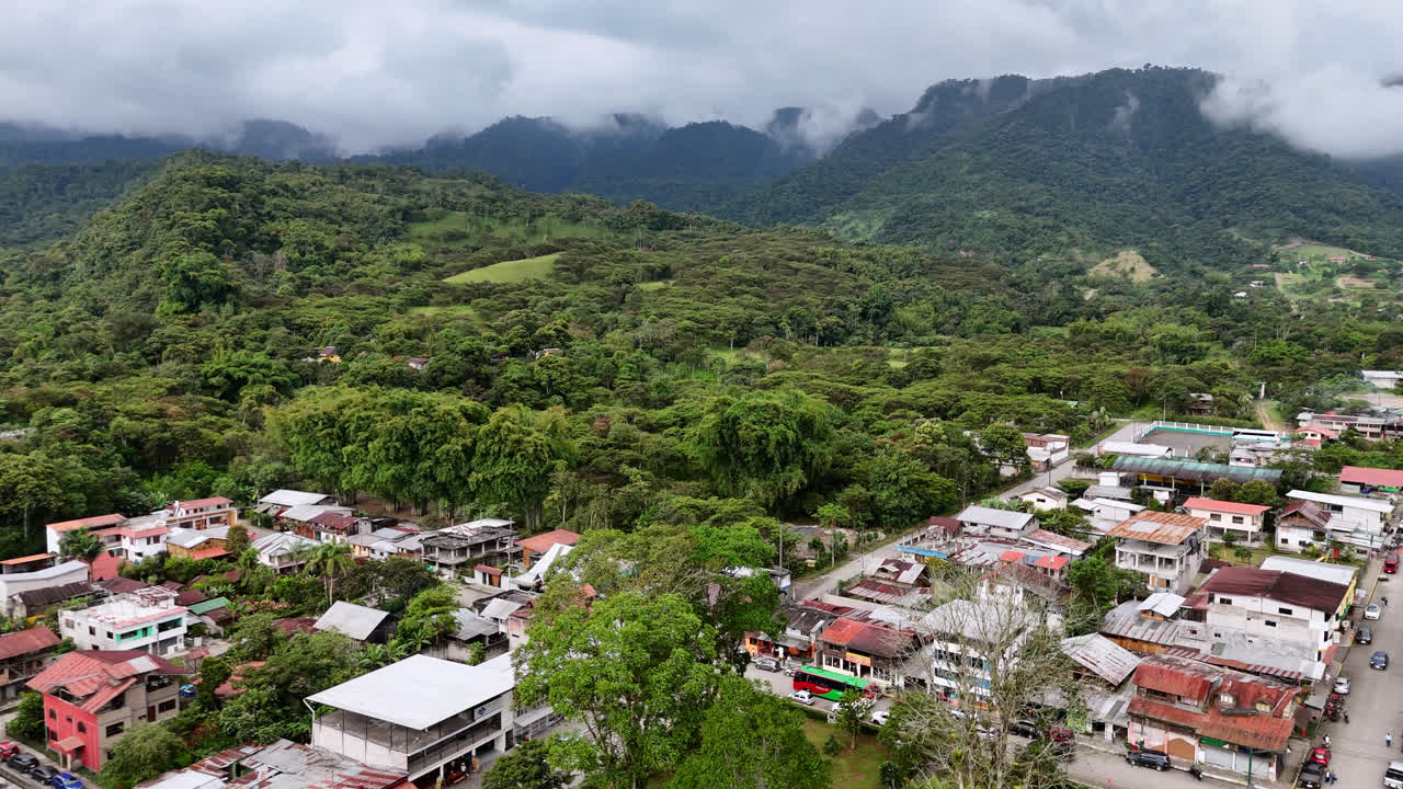 Fast Aerial View Of Mindo, Small Town In Ecuador Surrounded By Forest and Mountains, Wide View