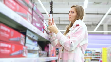 woman shopping for hair curler in a supermarket