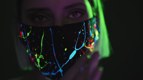 woman in fluorescent face mask posing