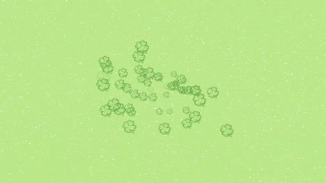 animation of snow falling over green clover leaves on green background