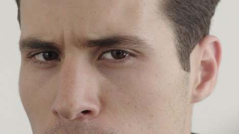 close up attractive young hispanic man face looking angry frowning