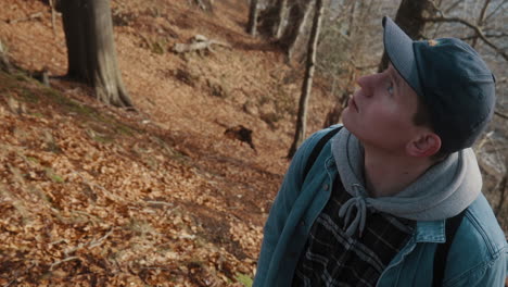 young-man-with-blue-eyes-watching-trees-thoughtfully