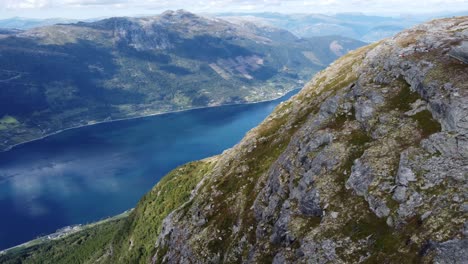 revealing hardangerfjord sorfjorden from majestic high altitude mountain hillside above lofthus norway - aerial from queens hiking trail looking towards kinsarvik and utne