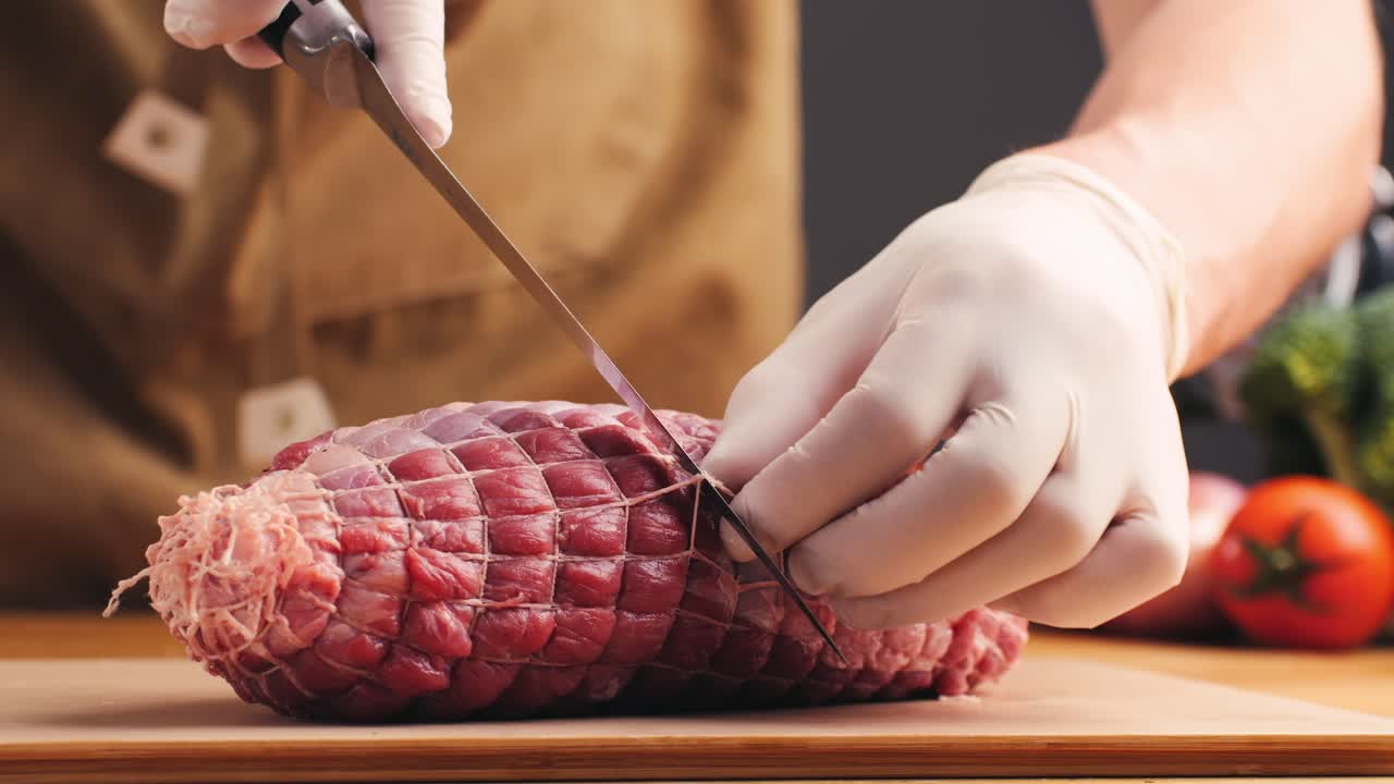 Chef preparing a tied roast