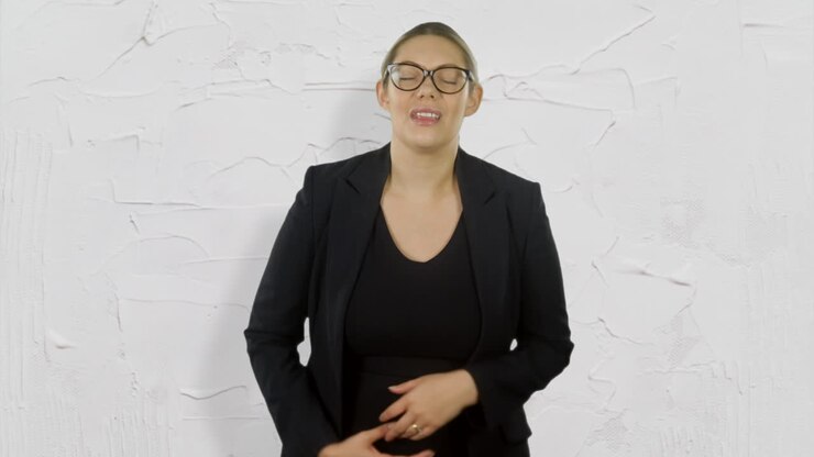 A businesswoman is suffering from stomach pain