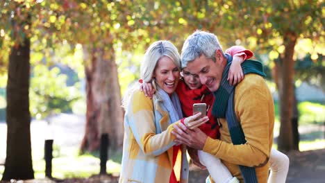 Parents-and-son-taking-a-selfie-on-mobile-phone-