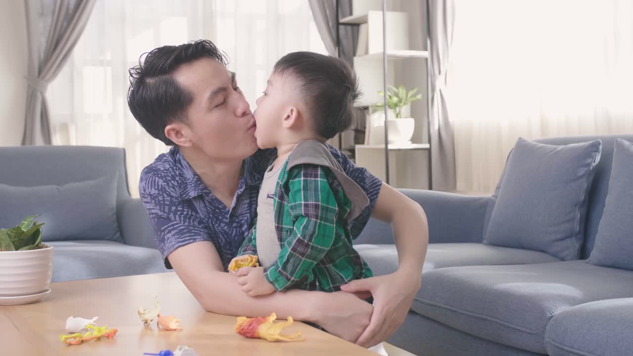 Happy Young Asian Father Kiss His Son At Home