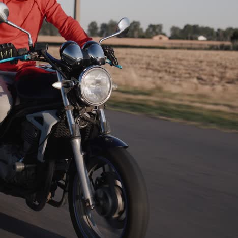 un joven monta una moto a lo largo de los campos de maíz 2