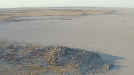 drone shot of spectacular og empty rocky desert at kubu island near makgadigadi pans, botswana