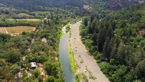 The-Russian-River-by-Healdsburg,-California-near-a-vineyard---aerial-orbiting-view