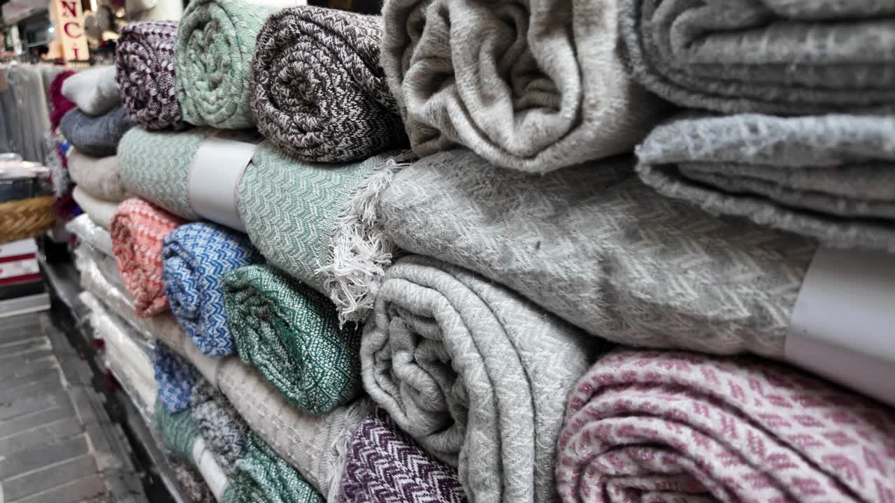 Colorful Rolled Blankets and Throws Stacked on Display
