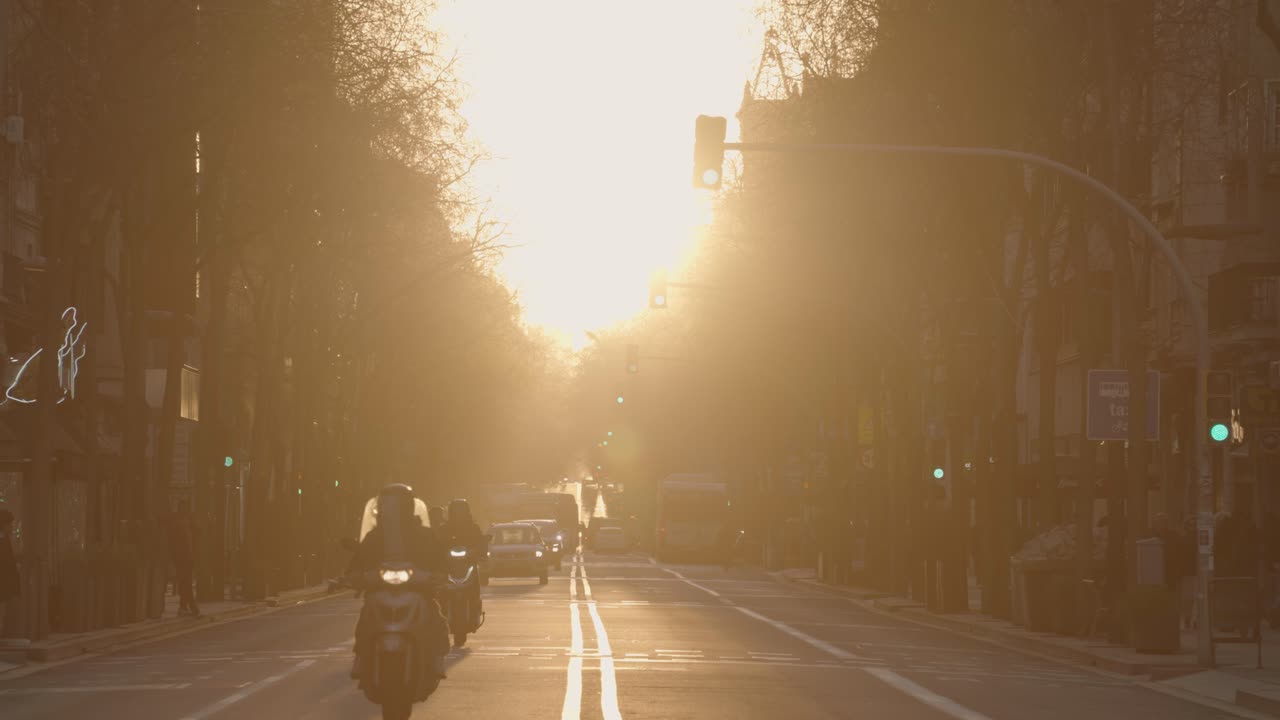City street with motorcycles at sunset