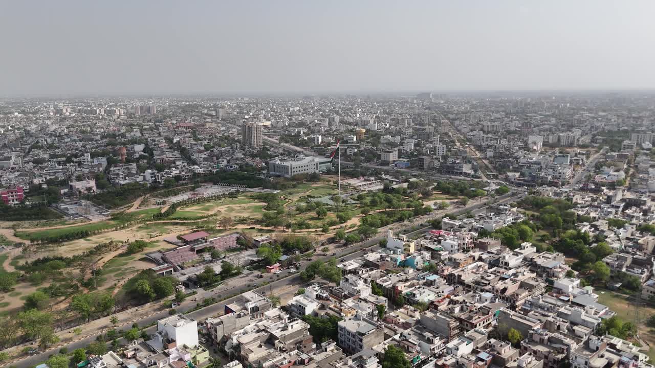 View of green patches and gardens among urban concrete buildings in Jaipur