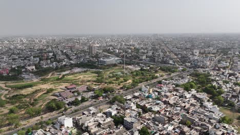 view of green patches and gardens among urban concrete buildings in jaipur