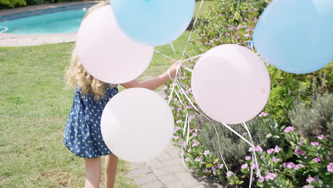 little blonde girl running with balloons in slow motion