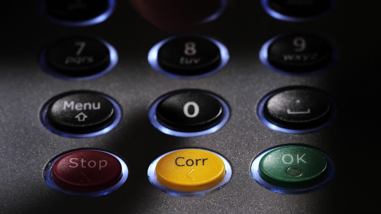 Close up of illuminated keypad as finger enters four digit code and confirms